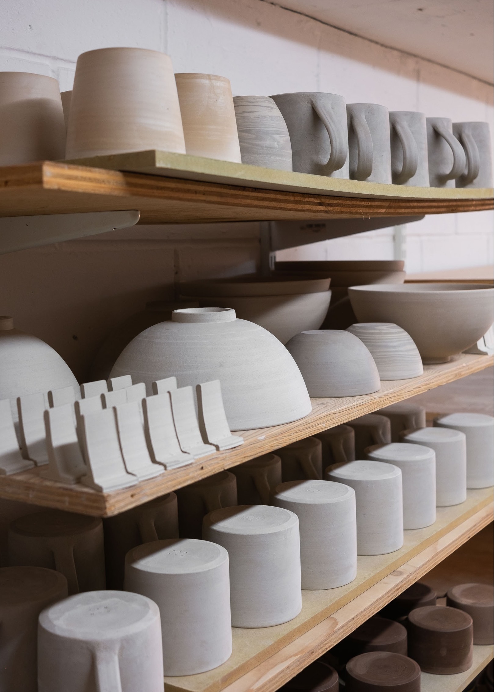 Greenware ceramics on shelves