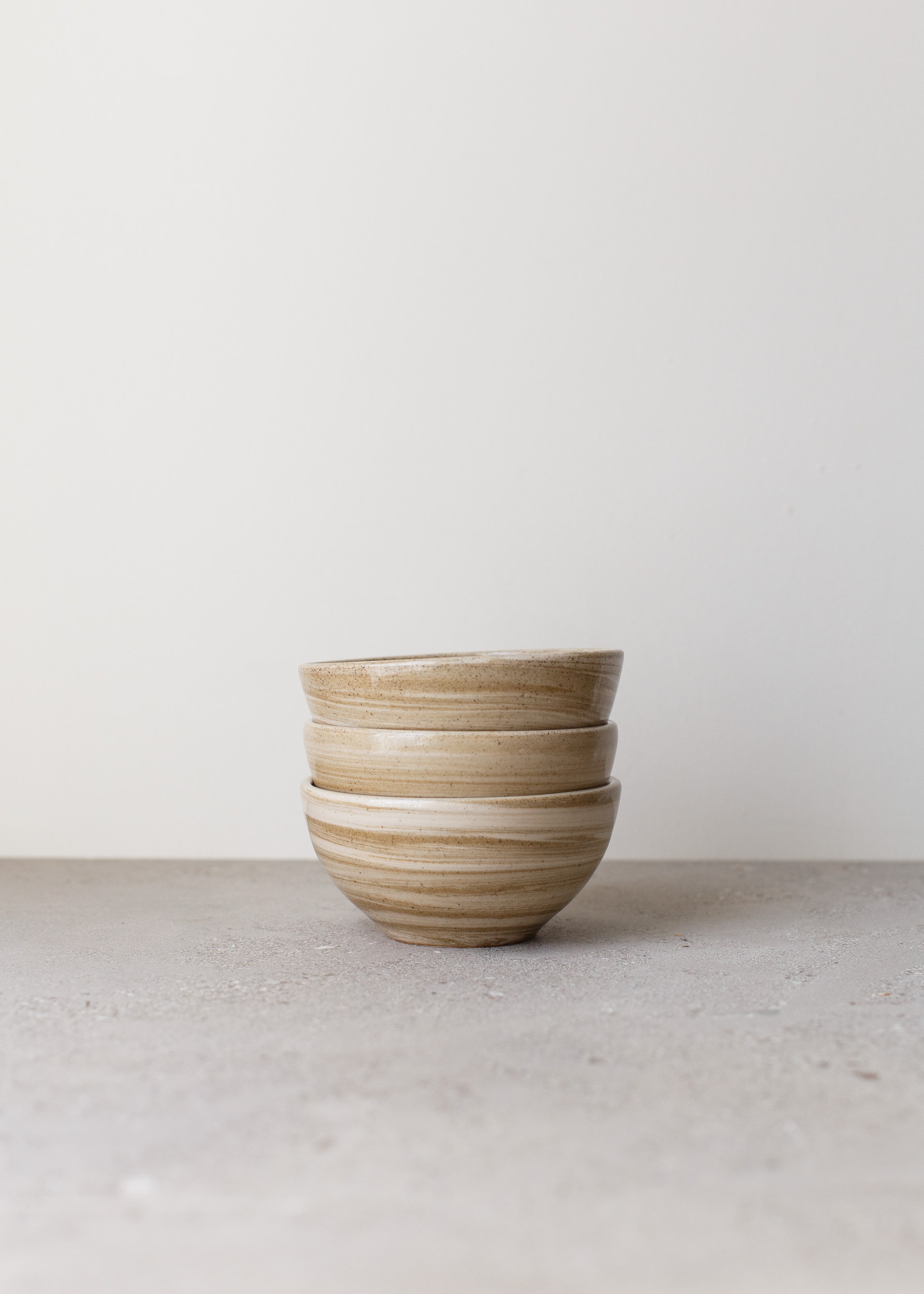 Stack of 3 white and light brown marbled bowls