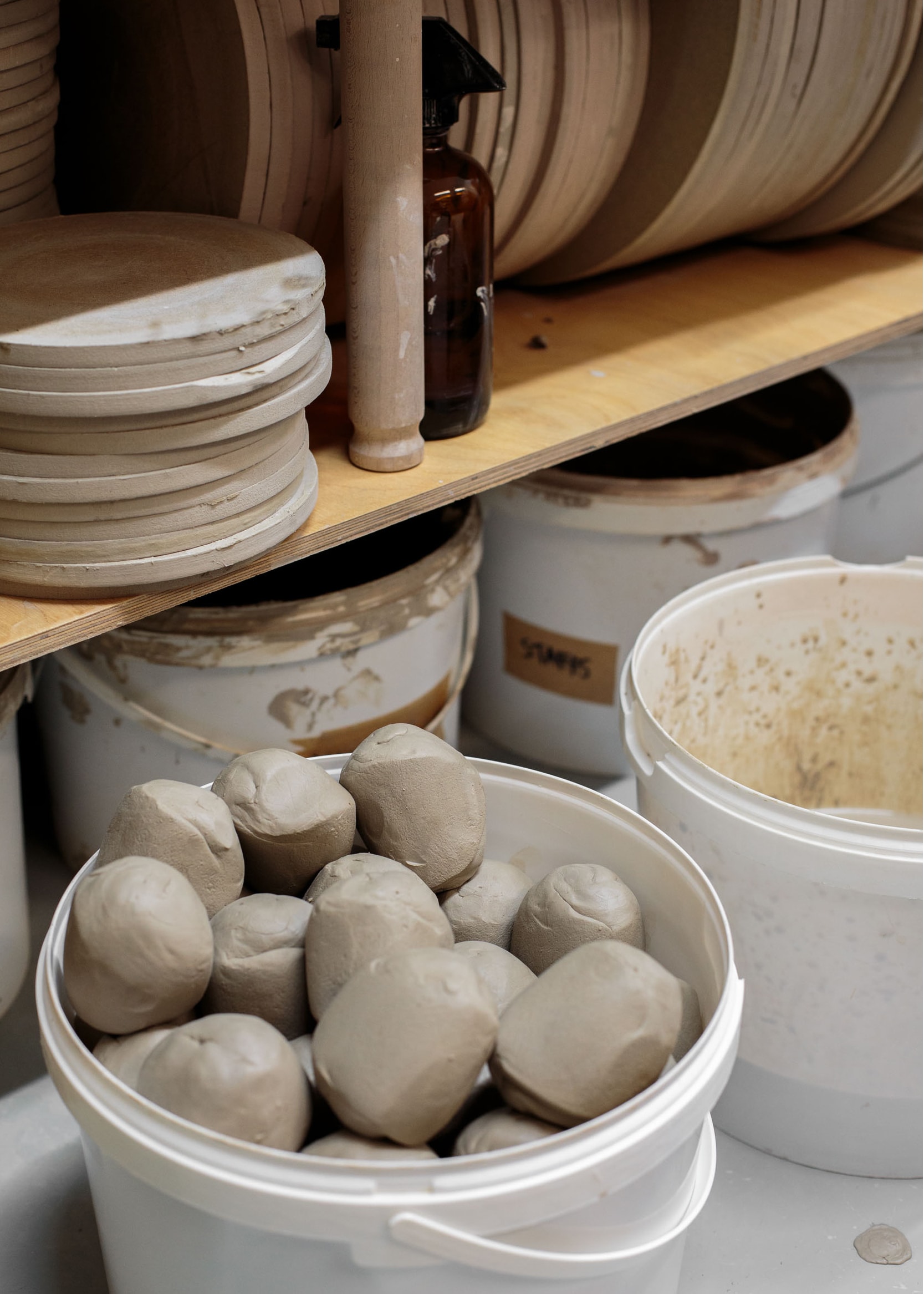 Bucket of prepared clay balls in pottery studio